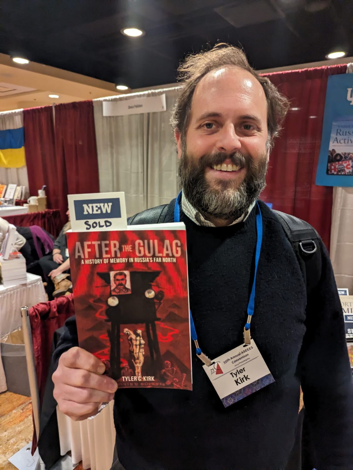 Tyler Kirk holds his newly published book, 鈥淎fter the Gulag: A History of Memory in Russia鈥檚 Far North,鈥� at the Association for Slavic, East European, and Eurasian Studies鈥� 55th annual conference in Philadelphia on Dec. 5, 2023. Photo courtesy of Tyler Kirk.
