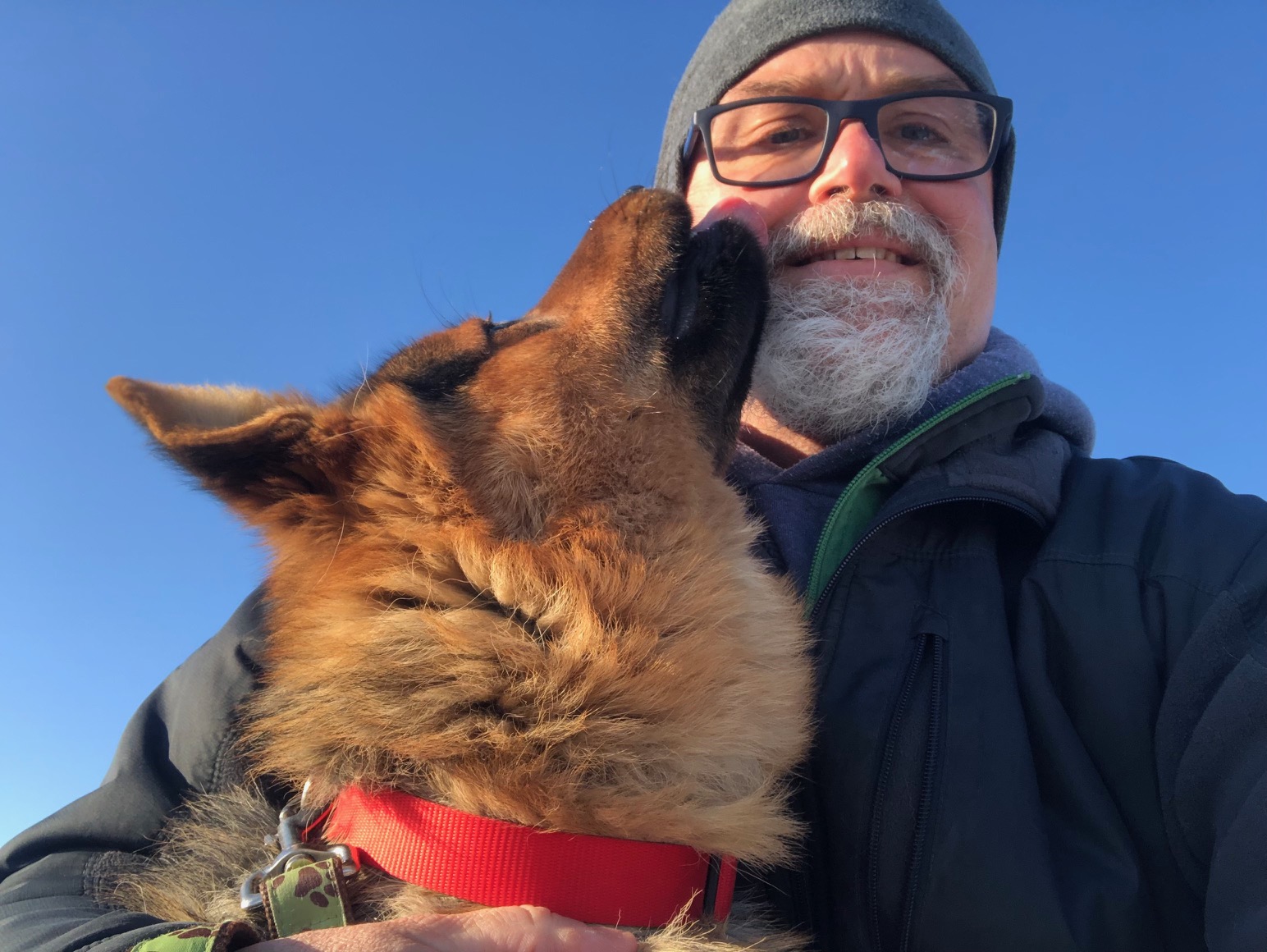 Pietsch (man) with a dog licking his face.